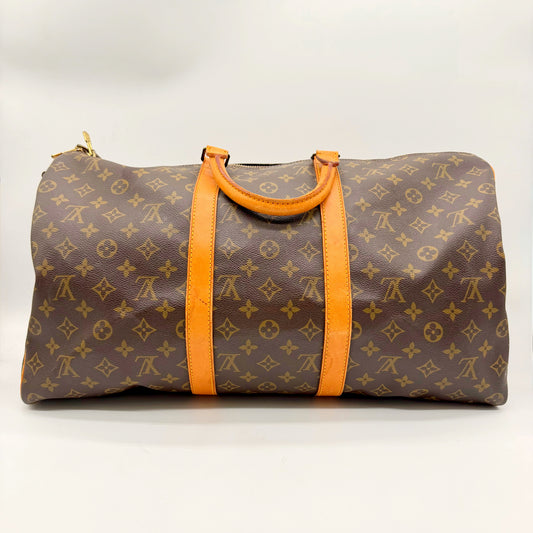 Louis Vuitton Keepall Bandoulière 50 en toile Monogram, face arrière et poignées en cuir naturel