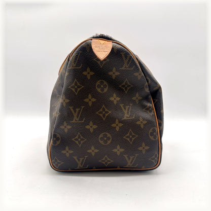 Louis Vuitton Speedy 30 Toile Monogram - côté avec patte en cuir naturel