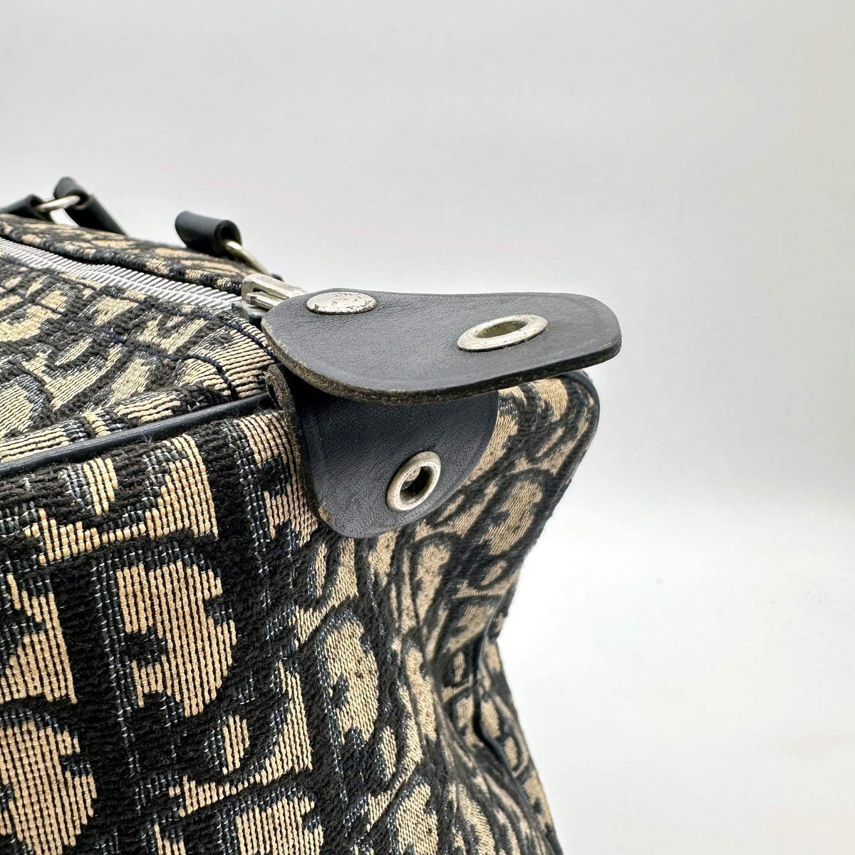Dior Boston 30 Toile Trotter - détail du haut du sac et de la patte à œillet