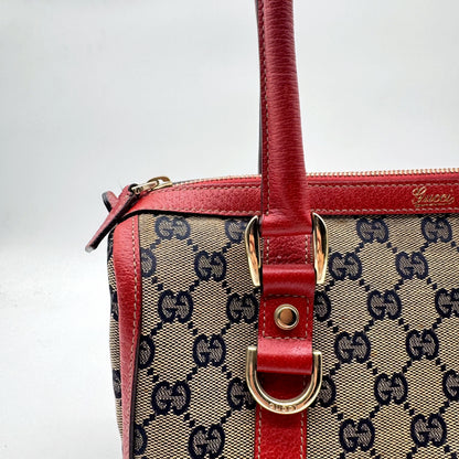 Gucci Boston Abbey Toile GG et Cuir Rouge - détail de l'anneau doré et du zip