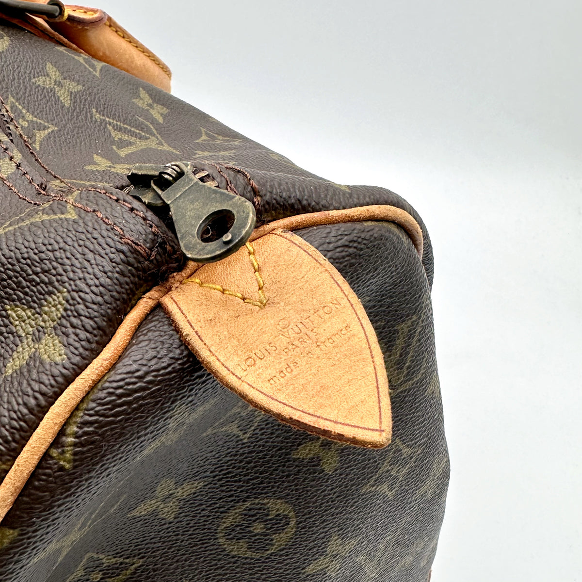 Louis Vuitton Keepall 45 Toile Monogram - détail du curseur de zip et de la patte de cuir