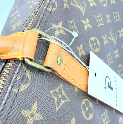 Louis Vuitton Keepall 55 Monogram - attache laterale et anse en cuir vachette