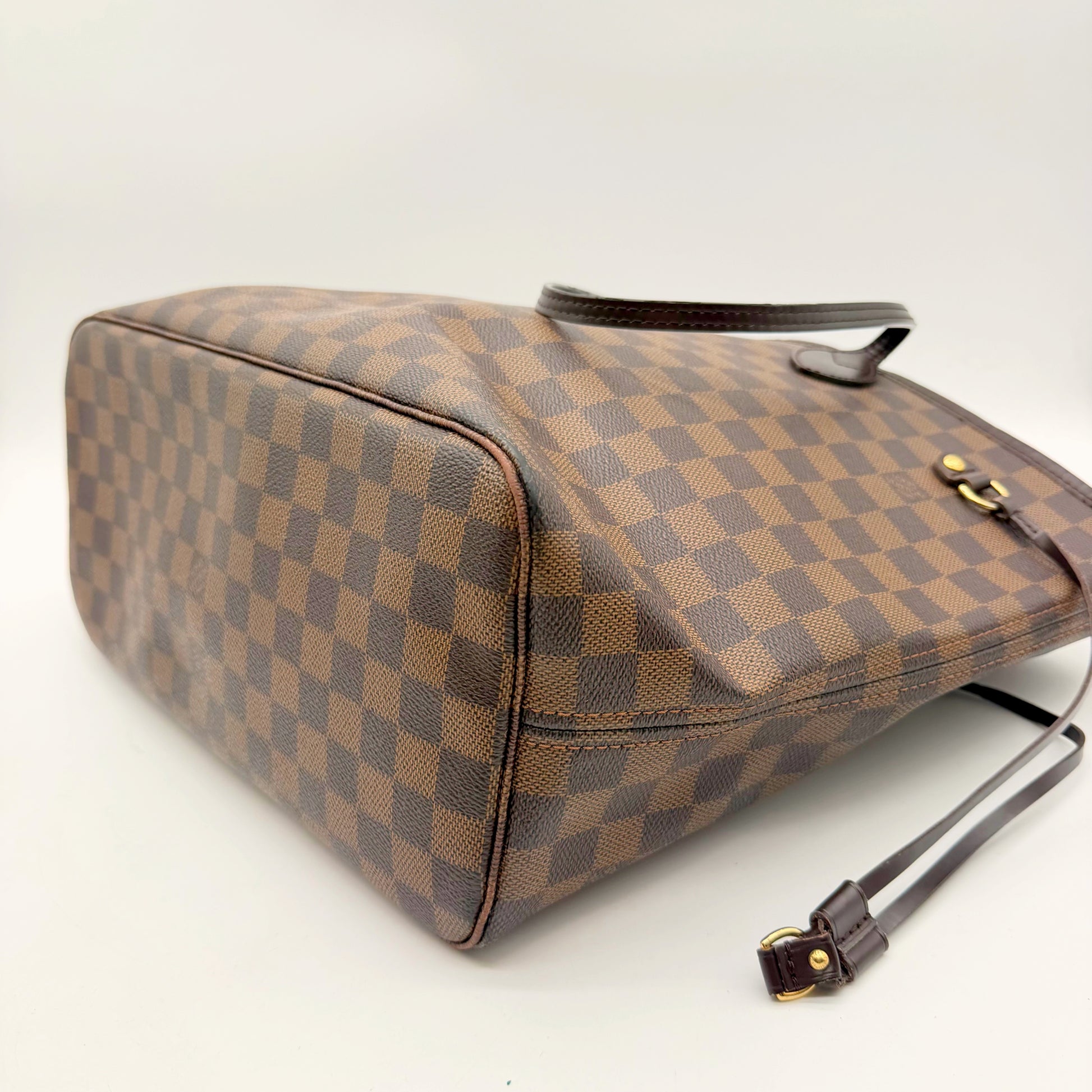 Louis Vuitton Neverfull MM toile Damier Ebene - vue trois quarts sur le fond et l'arete inferieure