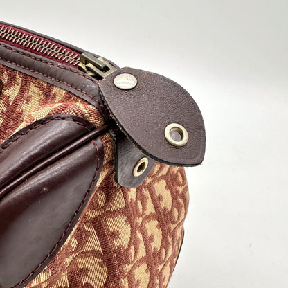 Dior Boston Toile Trotter Rouge - détail de la patte de cuir et de l'extrémité du zip