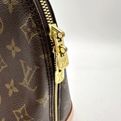Louis Vuitton Alma Toile Monogram - détail du zip et de sa tirette dorée
