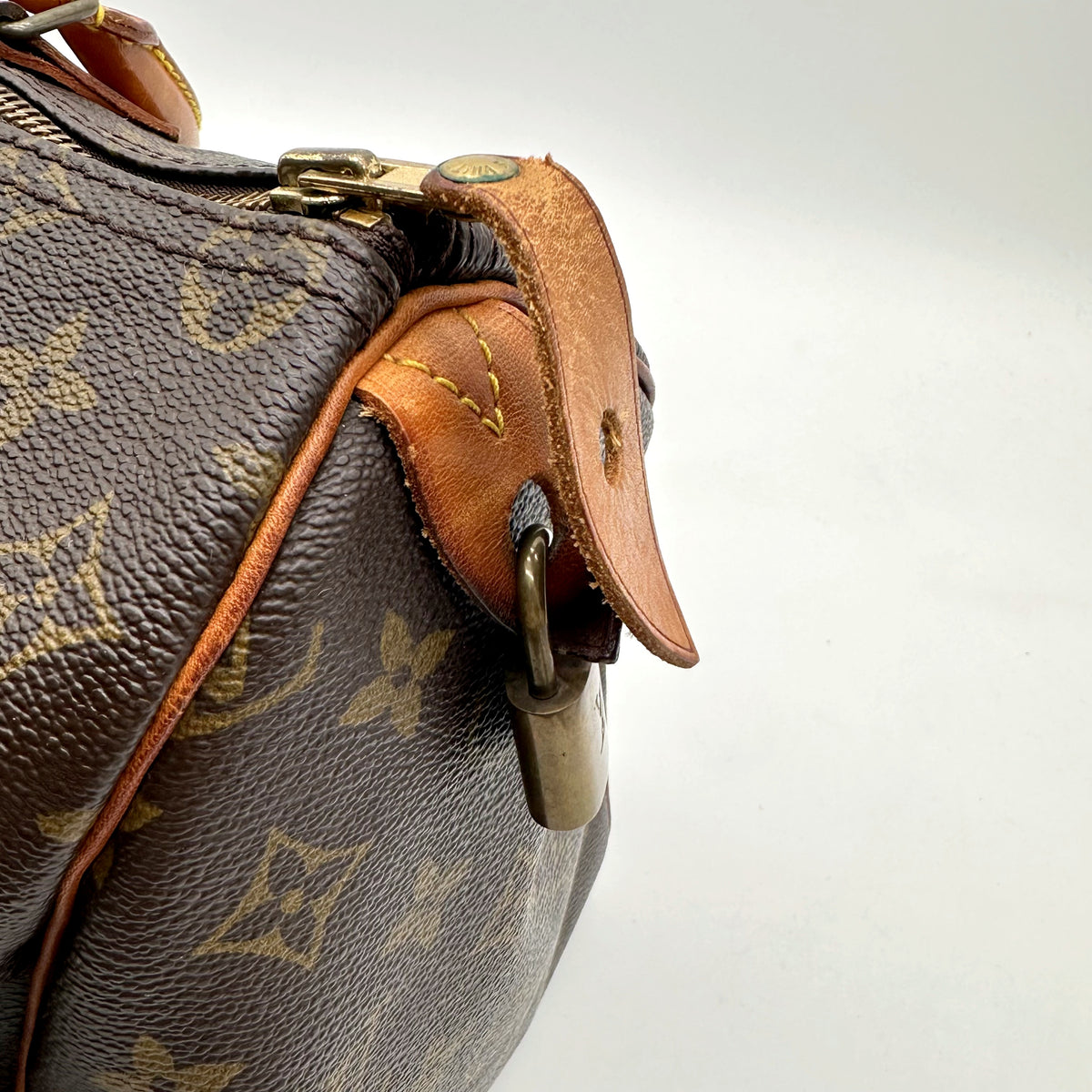 Louis Vuitton Speedy 35 Toile Monogram - détail de la patte de cuir latérale et du cadenas