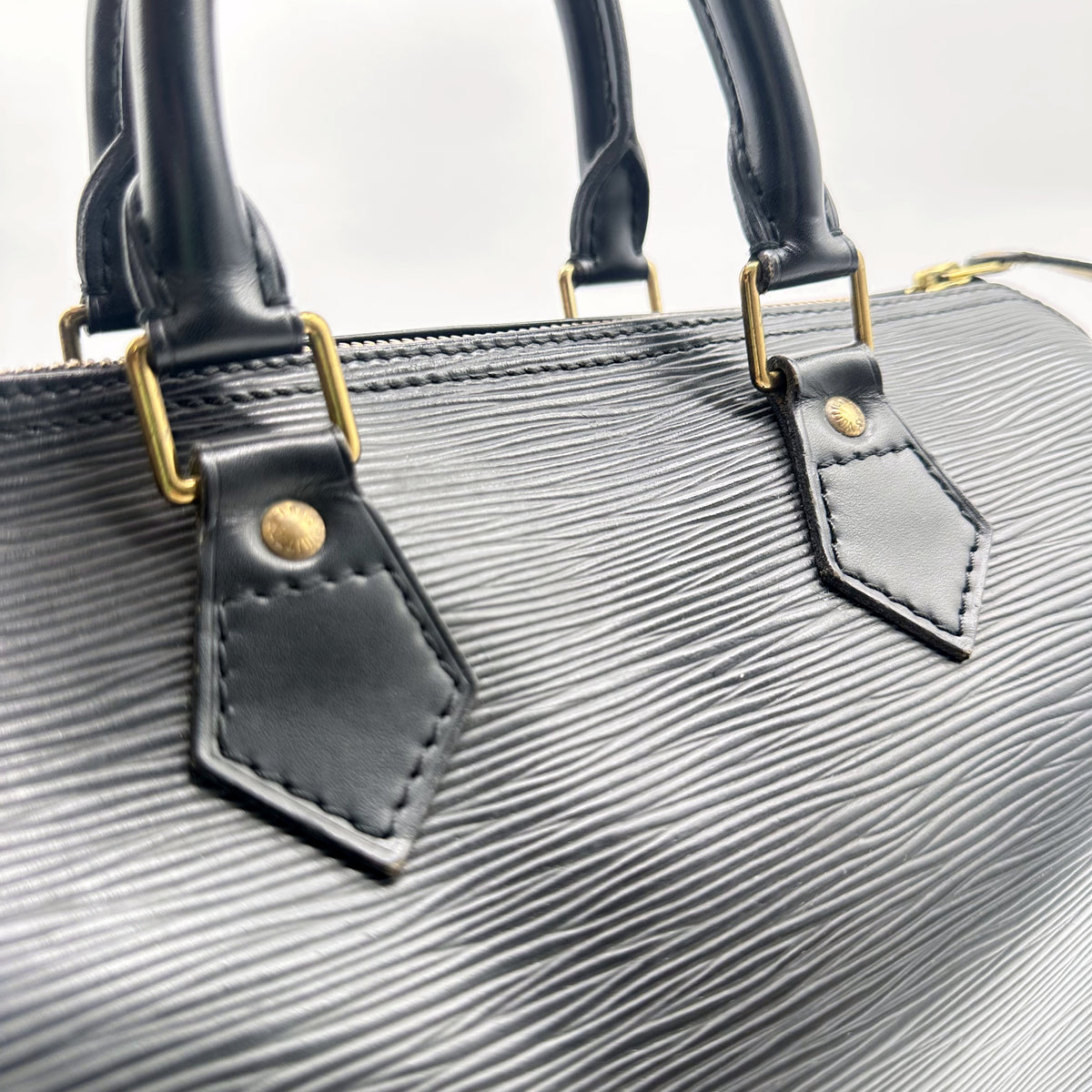 Louis Vuitton Speedy 25 Cuir Épi Noir - détail des attaches d'anses dorées