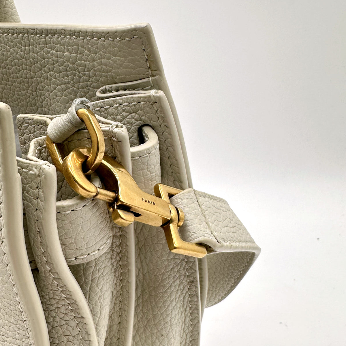 Saint Laurent Sac de Jour Baby Cuir Grainé Blanc Cassé - détail du mousqueton et du soufflet latéral