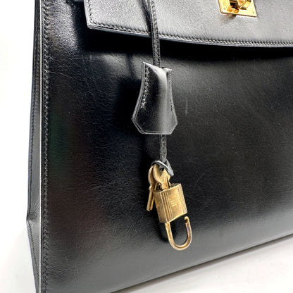 Hermès Kelly 32 Cuir Box Calf Noir - sac ouvert avec le cadenas et la clochette